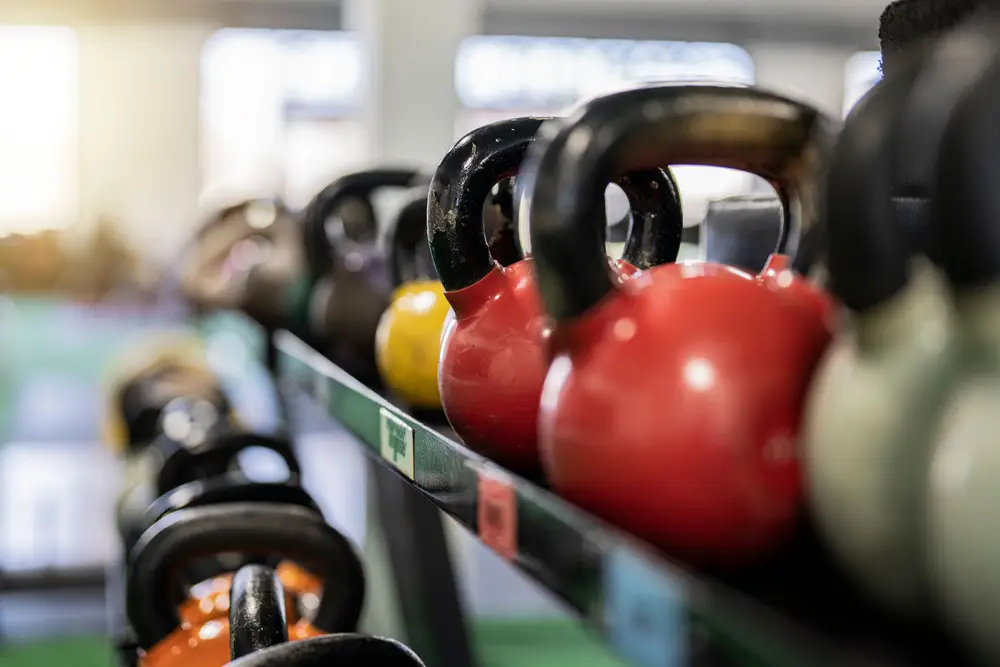 A rack of colourful kettlebells